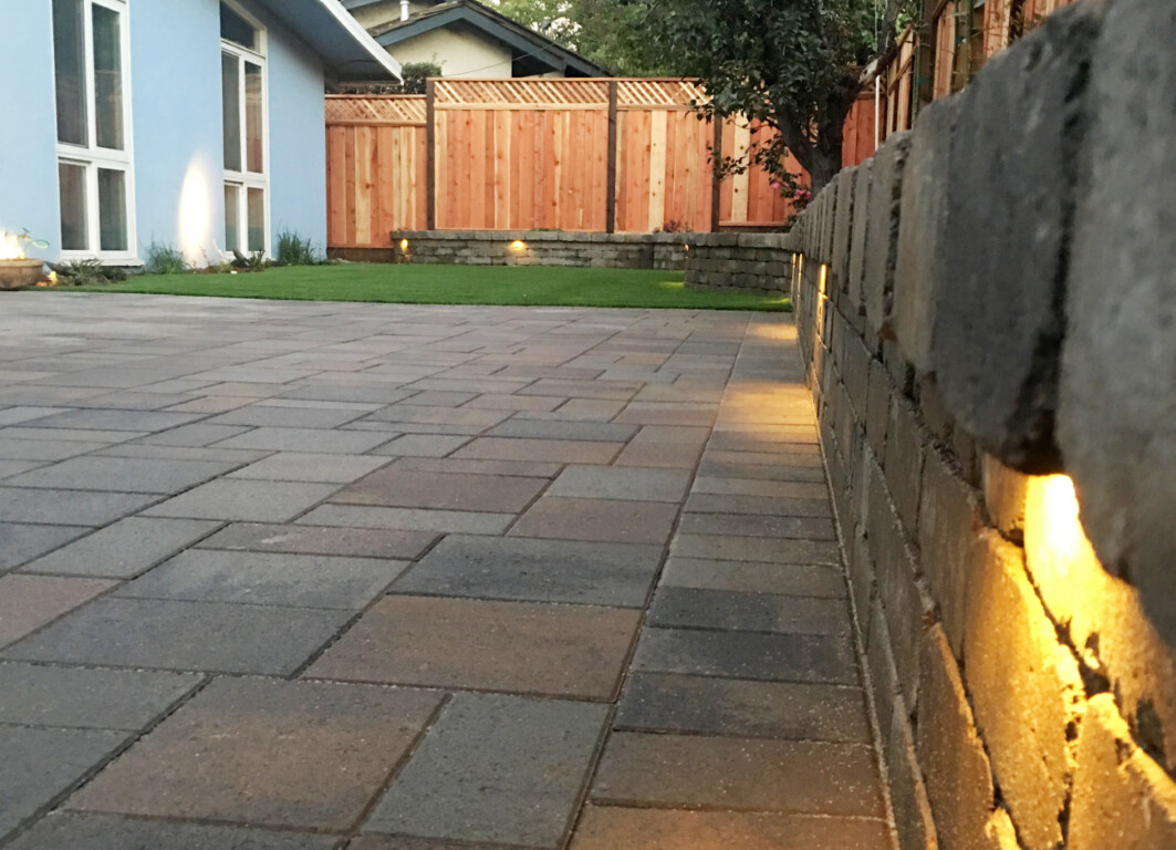 Concrete retaining wall and patio with elegant lighting features